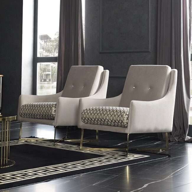 Atlas Accent Chair in modern grey and cream, showcasing bespoke luxury upholstery with sleek gold metal legs.