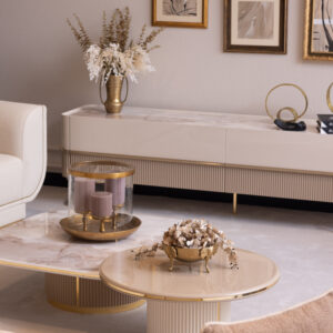 Modern TV unit with a cream high-gloss finish, marble-effect top, fluted detailing, and sleek gold legs, styled in an elegant living room setting.