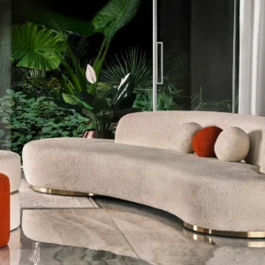 Luxurious Miami Curve Sofa with a curved silhouette, upholstered in custom boucle fabric, set on antique gold bases, featuring a high-quality hornbeam structure and high-density foam for ultimate comfort.