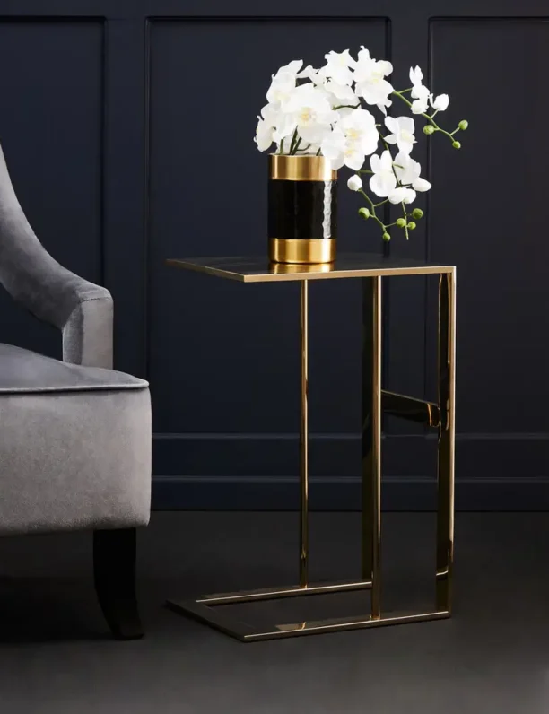 The Selene Gold C-Shaped Side Table adds an instant touch of luxury to any decor. Featuring a sleek, all-metal construction with a brilliant gold finish, this contemporary C-shaped table is both functional and stylish. Perfect for enhancing modern living rooms, bedrooms, or as an elegant accent next to your sofa. Features and Benefits: Elegant gold finish for a luxurious look C-shaped design for versatility and modern appeal Durable all-metal construction for lasting style Ideal for living rooms, bedrooms, or as a sofa-side accent