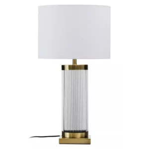 The contemporary Lily table lamp has a clean white fabric shade and a fluted crystal body adorned by gold finish metal rims