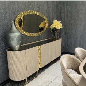 The Lyon Console redefines luxury. Designed with elegance and precision detailing this side unit features a melted gold effect over intricately riveted cupboard doors with co-ordinating metal edged oval mirror.  This stunning piece stretches 2.4 metres in length and is a true statement piece for your living space. Pair this piece with the rest of our Lyon Collection to create a luxurious ensemble. Bespoke made in black, cream or beige gloss and bronze or golden finishing.