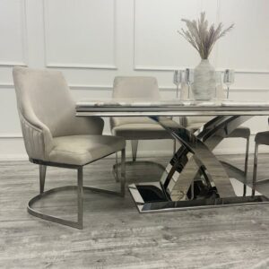 Elevate your dining space instantly with our new Roma Dining Table. This ultra-chic and stylish contemporary dining table redefines high-end living. Featuring a stunning 1.8-meter top available in luxurious marble or glass, as shown here in our warm and stylish Pandora Marble, it's paired with a polished stainless steel double x leg base. Our marble, Sintered Stone, and glass tops are not only incredibly hardwearing but also scratch-resistant. The sleek lines and smooth materials of the Roma Dining Table make it exceptionally easy to clean. With ample room for six dining chairs, it's the perfect centerpiece for your dining room.