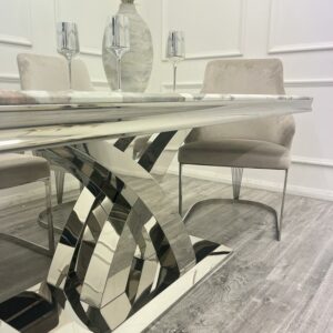 Elevate your dining space instantly with our new Roma Dining Table. This ultra-chic and stylish contemporary dining table redefines high-end living. Featuring a stunning 1.8-meter top available in luxurious marble or glass, as shown here in our warm and stylish Pandora Marble, it's paired with a polished stainless steel double x leg base. Our marble, Sintered Stone, and glass tops are not only incredibly hardwearing but also scratch-resistant. The sleek lines and smooth materials of the Roma Dining Table make it exceptionally easy to clean. With ample room for six dining chairs, it's the perfect centerpiece for your dining room.