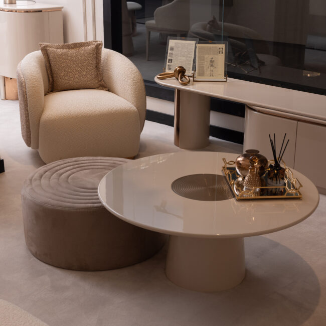 The Aurelia Coffee Table is a statement piece of modern sophistication, blending luxurious materials with timeless design. Part of the Aurelia Collection, it features a stunning cream gloss finish complemented by a rose gold reflective center that adds warmth and elegance to your living space. Its circular silhouette and sleek pedestal base make it a refined focal point, perfect for both contemporary and classic interiors. Features and Benefits: Elegant Design: Cream gloss finish with a rose gold reflective centerpiece. Modern Style: Circular silhouette with a sleek pedestal base. Part of the Aurelia Collection: Complements other luxurious pieces