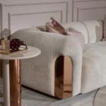 Stylish rose gold sofa with plush velvet upholstery and durable frame, adding luxury and warmth to modern living spaces. Perfect centerpiece for chic decor