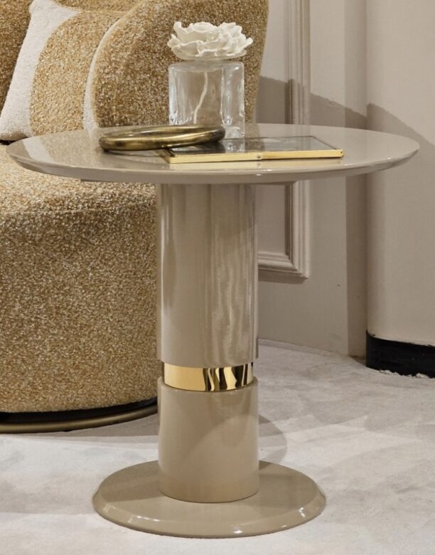 A bespoke accent table featuring a luxurious beige top complemented by elegant gold legs, perfect for adding a touch of sophistication to any room.