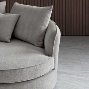 Serenity sofa in chic bouclé fabric with a curved design, blending durability and comfort for modern living spaces.