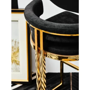 Elevate your bar area with the Piermont Bar Stool, boasting a luxurious black and gold color scheme. Inspired by the opulence of art deco design, its curved backrest and u-shaped base exude glamour. Wrapped in sumptuous velvet, the seat and backrest offer both style and comfort. Add a touch of sophistication to your space with the Piermont Bar Stool today