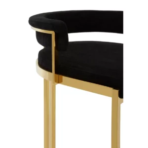 Elevate your bar area with the Piermont Bar Stool, boasting a luxurious black and gold color scheme. Inspired by the opulence of art deco design, its curved backrest and u-shaped base exude glamour. Wrapped in sumptuous velvet, the seat and backrest offer both style and comfort. Add a touch of sophistication to your space with the Piermont Bar Stool today