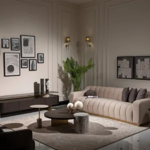 A cream-colored modern sofa featuring a sleek design with a luxurious gold plinth base, providing a sophisticated and elegant look suitable for contemporary interior settings.