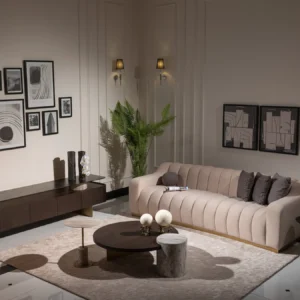 A cream-colored modern sofa featuring a sleek design with a luxurious gold plinth base, providing a sophisticated and elegant look suitable for contemporary interior settings.