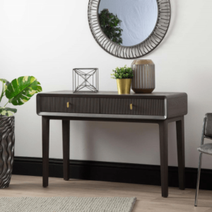 Introducing the Amelie Smoke Grey Elm 2 Drawer Console Table, a chic addition to your living space. Crafted from high-quality MDF with a sleek veneer finish in an elegant grey hue, this console table seamlessly combines practicality with contemporary style. With its two spacious drawers, it offers convenient storage solutions while adding a touch of sophistication to any room. Elevate your home decor with this versatile and refined furniture piece.