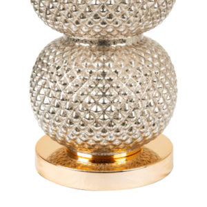 A sleek clear glass table lamp with a stacked ring-style base topped by a cream linen shade.