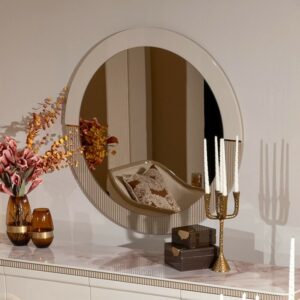 Belize Mirror with a round shape, featuring a modern design with split beige and cream colors, detailed rivet edging, and intricate gold detailing.