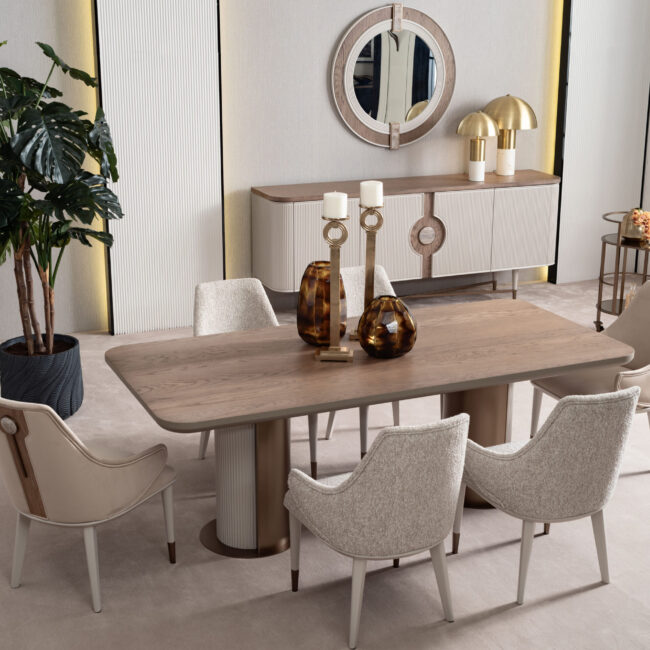 legant Serenity Dining Table with light oak wood top, cream upholstered chairs, and bronze accents, creating a sophisticated and modern dining space.