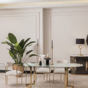 Elegant dining room featuring the Santorini Luxury Dining Set with a marble centerpiece and sleek glass top, surrounded by bespoke dining chairs upholstered in luxurious boucle fabric with gold metal frames, set against a stylish, modern interior