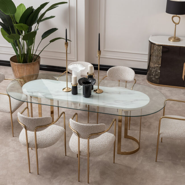 Elegant dining room featuring the Santorini Luxury Dining Set with a marble centerpiece and sleek glass top, surrounded by bespoke dining chairs upholstered in luxurious boucle fabric with gold metal frames, set against a stylish, modern interior