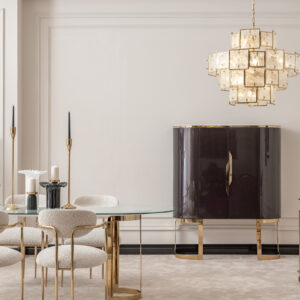 Elegant dining room featuring the Santorini Luxury Dining Set with a marble centerpiece and sleek glass top, surrounded by bespoke dining chairs upholstered in luxurious boucle fabric with gold metal frames, set against a stylish, modern interior