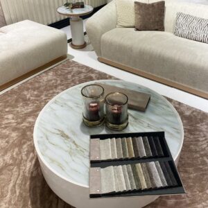 Round Odyssey Coffee Table in beige with tinted glass top and elegant gold plinth base