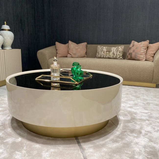 Round Odyssey Coffee Table in beige with tinted glass top and elegant gold plinth base