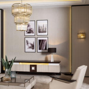 A spacious living room with a luxury TV unit featuring a dark wood top, cream and gold accents, and ribbed detailing, complemented by a matching coffee table and armchair.