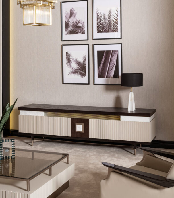 A spacious living room with a luxury TV unit featuring a dark wood top, cream and gold accents, and ribbed detailing, complemented by a matching coffee table and armchair.