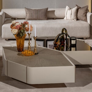 A set of two luxurious Sovrano coffee tables featuring a hexagon silhouette; one with a wooden top and the other with a glass top. Each table includes antique gold detailing, perfect for a sophisticated and abstract modern living room design.