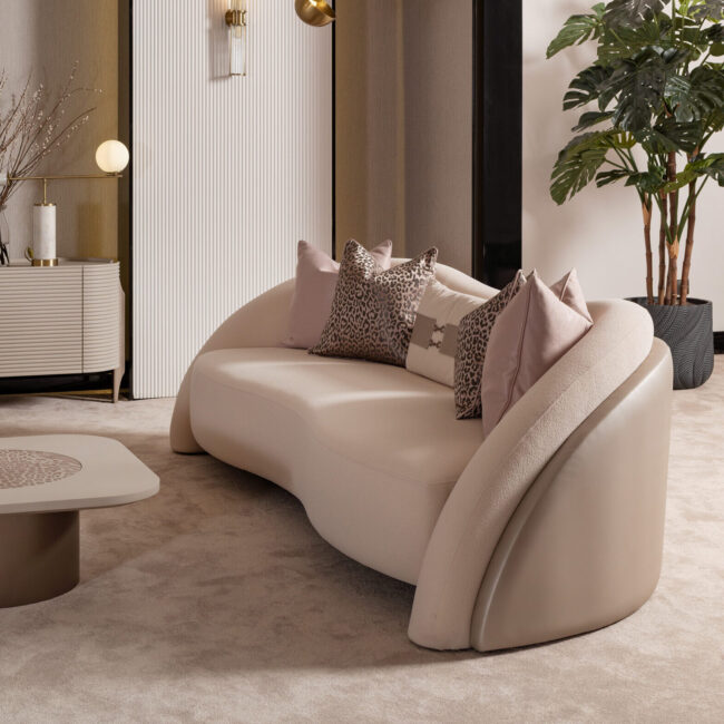 Bespoke Liora Sofa with a curved silhouette, plush upholstery, and a leather-wrapped back, available in various colors to match any home décor, showcasing luxury and modern design.