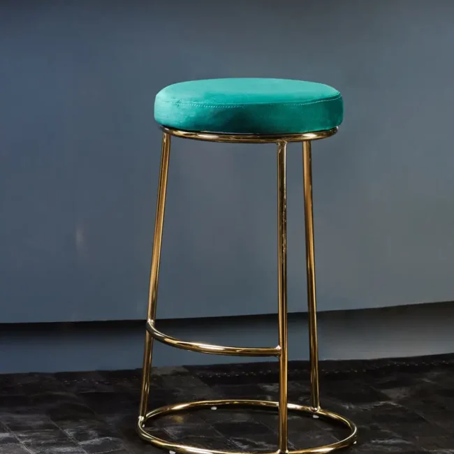 Luxe Teal Green Bar Stool with plush velvet upholstery and a sleek gold-finished frame, featuring a footrest for added comfort. Ideal for counter-height seating.