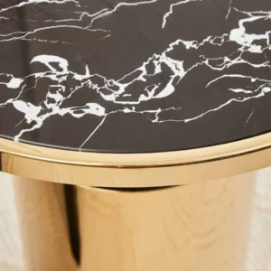 The Alessia Black Marble Effect Side Table complements any space with its luxurious black marbled glass top and sleek gold-finished base. The warm gold accents are perfectly balanced by the black column, creating a chic and sophisticated look. Designed to pair seamlessly with the Alessia Coffee Table, this side table brings both style and functionality to your living room, bedroom, or any modern interior. Features and Benefits: Black marble effect glass top for a luxurious finish Gold-finished base for added warmth and elegance Stylish balance of black and gold for a sophisticated look Dimensions: H50cm x L46cm x W46cm, ideal for modern interiors