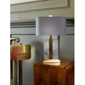 The Elisa Brass & Marble Table Lamp brings a sleek and contemporary touch to any room. Standing at 59cm, it features a stunning grey marble-inspired base with natural grain details, enhanced by elegant brass accents. The warm, rich slate grey linen shade adds a sophisticated contrast, making it a perfect fit for modern interiors.