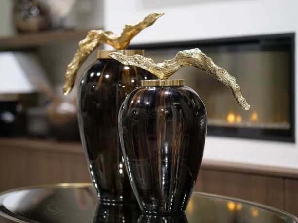 Make a bold statement with the Arlo Grande Decorative Jar, a stunning piece that beautifully blends rich chocolate and ebony tones. Its luxurious glazed finish is perfectly complemented by an elegant gold lid, creating a sophisticated focal point for any console or shelf.