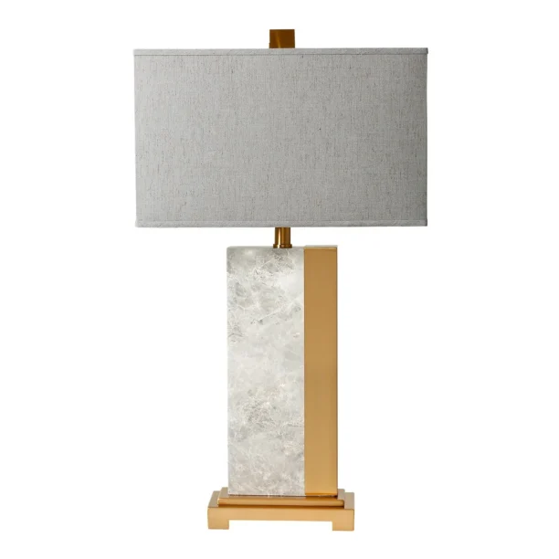 The Solara Marble & Brass Table Lamp is a contemporary piece featuring a sleek white marble stem with brass accents and base. Standing at 77cm, this elegant lamp adds a refined touch to any room in your home. Each lamp is unique due to the natural stone variations, making it a perfect statement piece. Pair with the matching floor lamp for a cohesive look. Features and Benefits: Height: 77cm, Shade Diameter: 43cm White marble stem with brass accents and base Unique natural stone variations in each piece Matching floor lamp available for a complete look