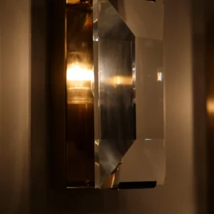 Belgravia crystal and brass wall light with faceted glass prisms reflecting light, luxury lighting for modern and classic interiors.