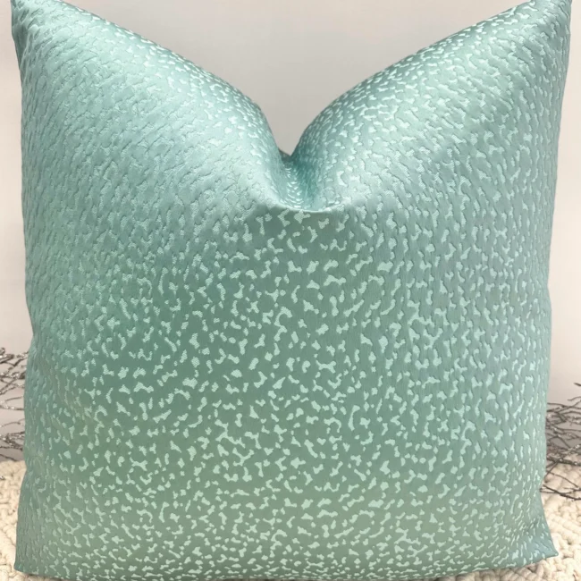 The Vivara Teal Luxury Cushion is designed to bring a bold pop of color and texture to your space. With its stunning teal hue and customizable size options, this cushion can be tailored with either 100% luxury duck feather or polyester inserts for your desired comfort. The invisible zip fastening ensures a sleek, seamless finish, making the Vivara cushion both elegant and practical. If you’re uncertain about the color, feel free to request fabric samples, or consult our in-house interior designers for personalized advice on fabric selection and cushion styling. Features and Benefits: Customizable in a range of sizes Choice of luxury duck feather or polyester inserts Invisible zip for a seamless finish Striking teal hue for a vibrant decor accent Personalized design assistance available from expert designers