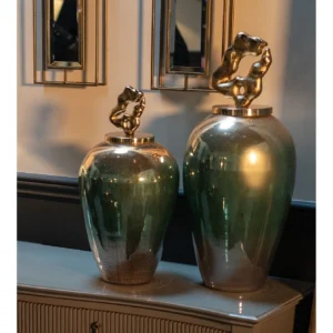 with a gilded, sculptural lid, adding a touch of grandeur to any space. Perfect for console or shelf styling, the Solara Luxe jars embody luxurious sophistication in every detail. Please note that due to the hand-painted finish, slight variations in color and finish enhance the unique charm of each piece. Features and Benefits: Three-color ombre design in gold, green, and white Sculptural gold lid for a statement look Available in a trio of sizes for versatile styling Hand-painted finish for unique variation Ideal for adding luxury to any space