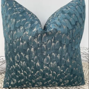 The Seraphina Peacock Cushion features a luxurious peacock gold and teal fabric, with a semi-plain textured surface that exudes elegance. Perfect for adding a timeless and sophisticated touch to any upholstered area in your home, these cushions are handcrafted by a couture tailor to ensure a high-quality finish. The Seraphina cushion is available with luxury feather inserts or without, and can be customized with a variety of piping options to suit your taste.