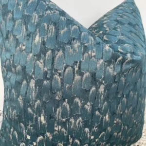 The Seraphina Peacock Cushion features a luxurious peacock gold and teal fabric, with a semi-plain textured surface that exudes elegance. Perfect for adding a timeless and sophisticated touch to any upholstered area in your home, these cushions are handcrafted by a couture tailor to ensure a high-quality finish. The Seraphina cushion is available with luxury feather inserts or without, and can be customized with a variety of piping options to suit your taste.