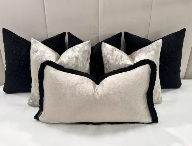 Add a sophisticated touch to your home with the Luxury Black and Cream Cushion Set. Features velvet cushions with gold detailing, handcrafted quality, and optional feather inserts.