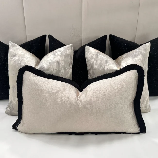 Add a sophisticated touch to your home with the Luxury Black and Cream Cushion Set. Features velvet cushions with gold detailing, handcrafted quality, and optional feather inserts.