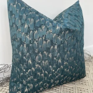 The Seraphina Peacock Cushion features a luxurious peacock gold and teal fabric, with a semi-plain textured surface that exudes elegance. Perfect for adding a timeless and sophisticated touch to any upholstered area in your home, these cushions are handcrafted by a couture tailor to ensure a high-quality finish. The Seraphina cushion is available with luxury feather inserts or without, and can be customized with a variety of piping options to suit your taste.