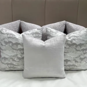 Add calming elegance to your space with the Luxury Grey Vestige Cushion Set. Bespoke handmade cushions in grey and silver, featuring luxury feather inserts.