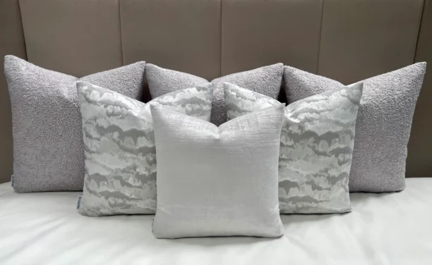 Add calming elegance to your space with the Luxury Grey Vestige Cushion Set. Bespoke handmade cushions in grey and silver, featuring luxury feather inserts.