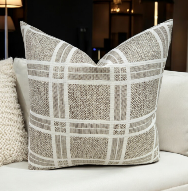 Enhance your home décor with the elegant Beige Plaid Cushion Featuring a sophisticated beige and white plaid pattern, this cushion cover adds a touch of rustic charm and timeless style to any space. The high-quality weaving technique ensures durability and a unique texture that stands out in any room. This stunning brown/taupe textured cushion beautifully complements any room.