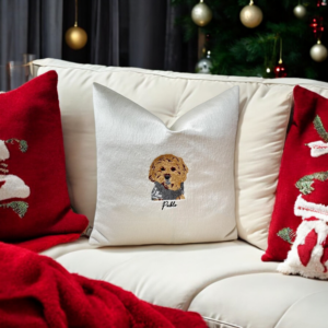 Handcrafted Pawtrait Cushion with custom pet embroidery on warm white fabric, featuring invisible zip fastening and luxurious feather insert.