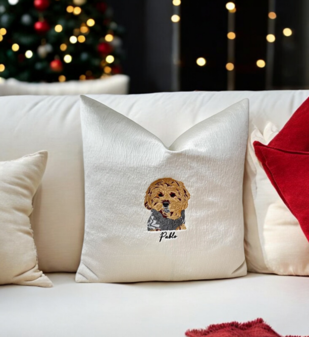 Handcrafted Pawtrait Cushion with custom pet embroidery on warm white fabric, featuring invisible zip fastening and luxurious feather insert.