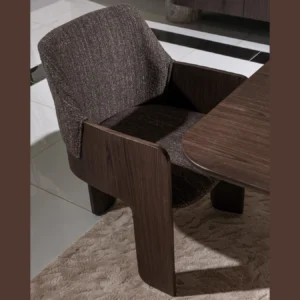 Palermo dining table with dark wood tabletop, travertine stone pillar, and brushed metal leg with gold accents.