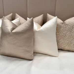 Add elegance to your home with the Luxury Champagne Cushion Set. Includes bespoke handmade cushions in champagne, ivory, and putty. Optional 100% feather inserts available. Perfect for a luxurious 2024 upgrade.