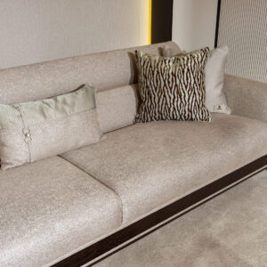 Sensatori Luxury Sofa with dark wood accents and plush beige upholstery, featuring bespoke design options in a variety of fabrics and finishes.